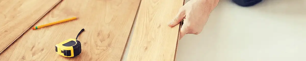 A professional installing wood flooring in Orange, CA