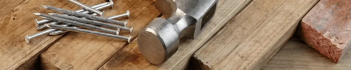 Hammer and nails on hardwood flooring boards in Orange, CA