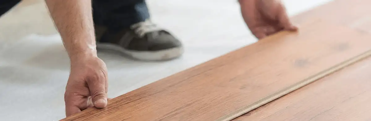 A professional installing laminate flooring in Orange, CA