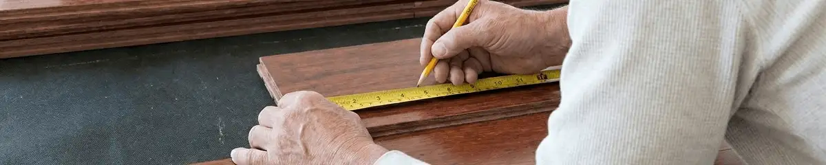 A professional installing wood flooring in Orange, CA